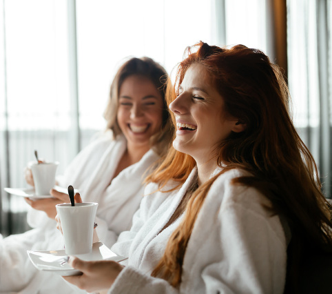 women in robes enjoying relation time